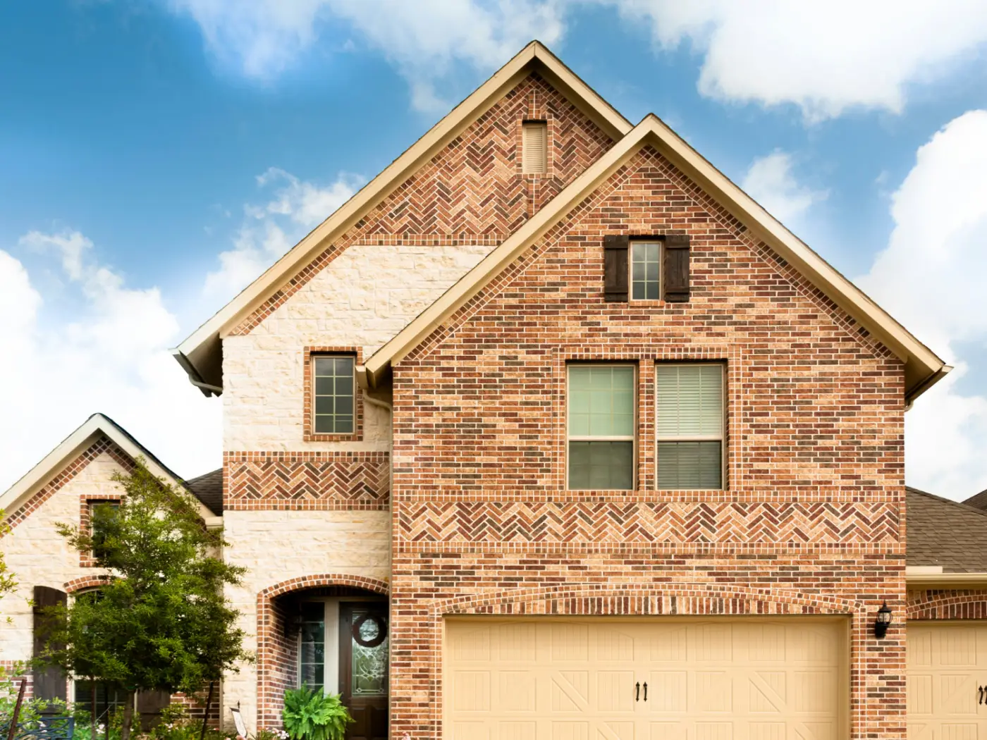 North Texas brick and stone home under a bright sky